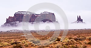 Clouds are creeping in on Saddleback and King on his Throne in Monument Valley Navajo Tribal Park