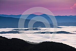 Clouds drenched valley below the level of the mountains.