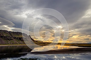 Clouds at dusk, reflected on a river, Iceland.
