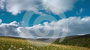 clouds float on the horizon in the mountains