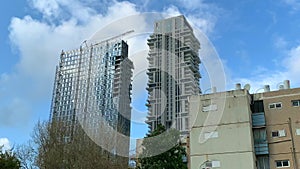 Clouds float over high-rise buildings under construction, time lapse