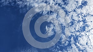 The clouds are fluffy and white against a backdrop of deep blue. photo