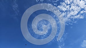 The clouds are fluffy and white against a backdrop of deep blue. photo