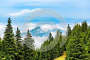 Clouds and fog covered mountain peak photo