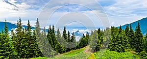 Clouds and fog covered mountain peak panortama photo