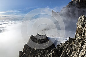 Clouds and fog near Aiguille du Midi. View from the Cosmique refuge, Chamonix, France. photo