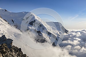 Clouds and fog near Dome du Gouter and Bosson glacier Mont Blanc massif in the French Alps. View from the Cosmique refuge,