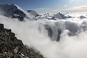 Clouds and fog over the Chamonix valley. View from the Cosmique refuge, Chamonix, France. Perfect moment in alpine highlands photo