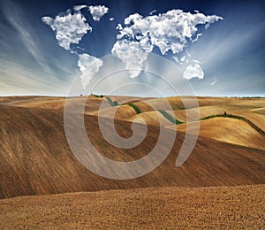 Clouds in the form of a map of the world over the field. Travel and landscape concept