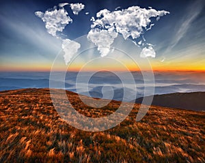 Clouds in the form of a map of the world over the mountains. autumn dawn in the Carpathians. Travel and landscape concept