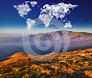 Clouds in the form of a map of the world over the mountains. autumn dawn in the Carpathians. Travel and landscape concept