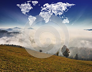 Clouds in the form of a map of the world over the mountains. autumn dawn in the Carpathians. Travel and landscape concept