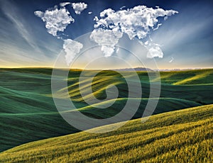 clouds in the form of a world map over a green field. Travel and landscape concept