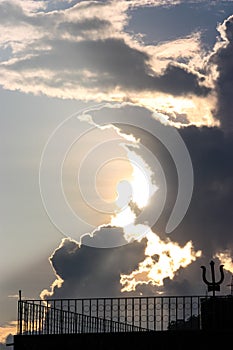 Clouds in front of the sun create a divine scene with a sacred symbol in Rishikesh