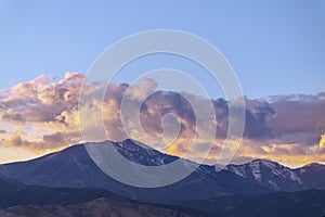 Clouds gathering over the mountain at sunset