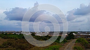 Clouds, grassland, saltpan, emptyness and a road