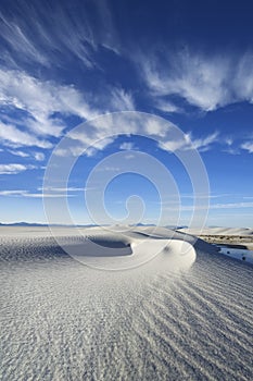 Clouds hang above the swirling dunes of White Sands National Park.