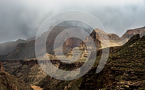 Clouds Hang Between The Layers of Rock Showing The Levels Of Grand Canyon