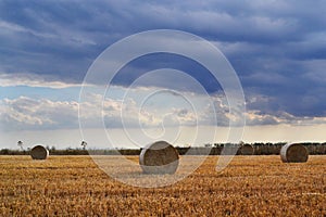 Clouds on hay summer field