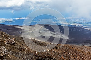 The clouds lift briefly to reveal the meandering track up to the summit of Mount Etna, Sicily