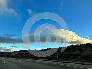 Clouds lit by sun along the highway in the Tejon Pass