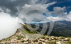 Clouds meet the top of a mountain ridge on GR20 in Corsica photo