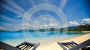 clouds motion above sea beach chairs on sand on foreground