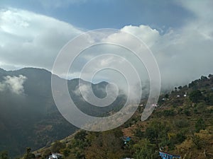 Clouds and mountains meeting in  a village in himalayan region  in India