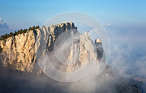 Clouds move below rocks on the mountain Ai Petri