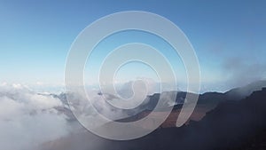 clouds moving across the landscape from the summit of haleakala in maui hawaii