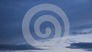 Clouds moving on darkening sky, time lapse scene