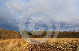 clouds over an agricultural field in autumn