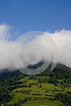 Clouds over forested mountains