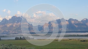 Clouds over the Grand Teton mountains at sunrise