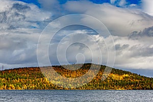 Clouds over the lake in the mountainous part of the tundra in autumn