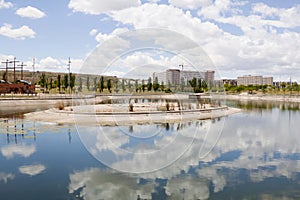 Clouds over a lake, a park and an urbanization