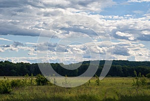 Clouds over meadows and fields in the valley