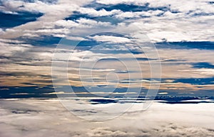 Clouds over mountains in blue sky