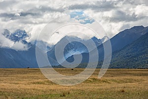 Clouds over the mountains in New Zealand photo