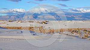 Clouds over mountains in white gypsum sands. White Sands National Monument in New Mexico, USA