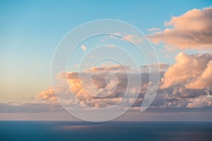 Clouds over ocean, evening sky above ocean horizon