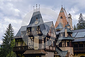 Clouds over Pelisor castle roof in Sinaia, Romania, a Summer destination for tourism, architecture, sightseeing