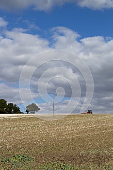 Clouds over recently tilled farmland photo