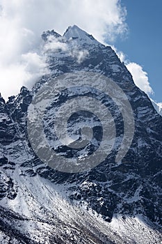 Clouds over rocky unclimbed Peak 5939, Himalaya, Nepal