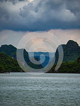 Clouds over the sleeping mountains in halong photo