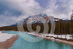 Clouds Over A Snowy River Landscape In The Banff Mountains
