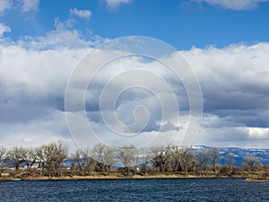 Clouds over a western Colorado lake with the Grand Mesa in the Background