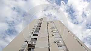 Clouds pass over a modern building, timelapse. Clouds passing over residential area in city. Modern skyscraper. Time lapse of clou