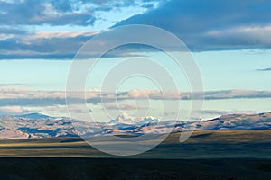 Clouds passing over mountain pinnackle in sunset light