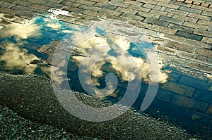 Clouds through Puddle